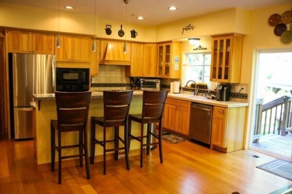 A kitchen with wooden floors and cabinets